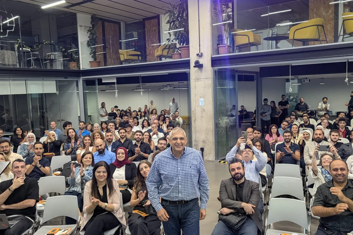 Halim Debbas smiling as the audience applauds his win at Kanz AI Night in Beirut